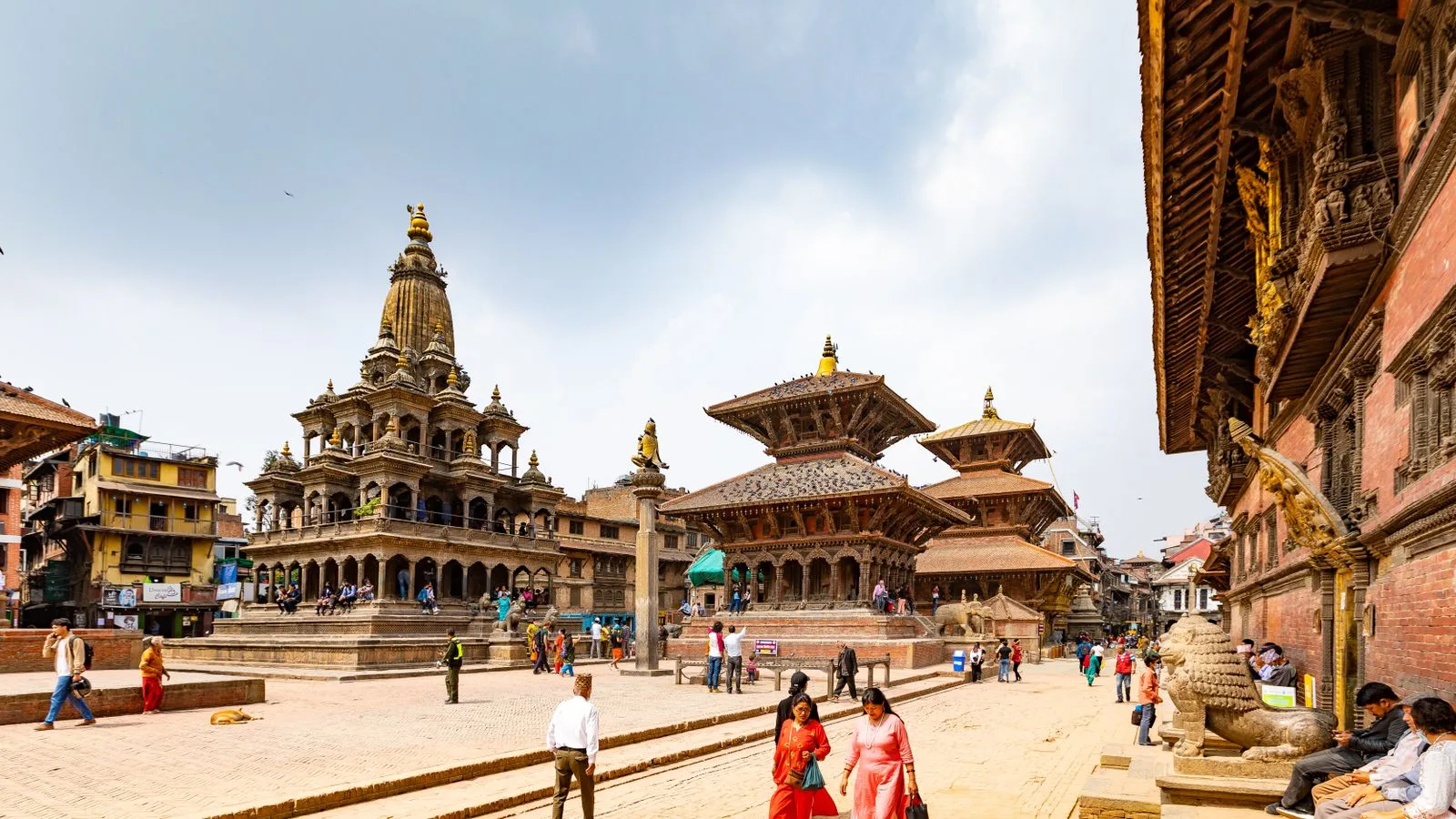 Tourists walking among the pagoda temples of Patan Durbar Square in Kathmandu, Nepal